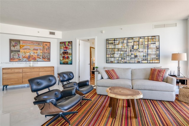 tiled living room with a textured ceiling