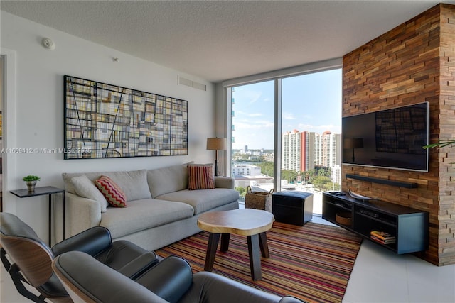 living room with a wall of windows and a textured ceiling