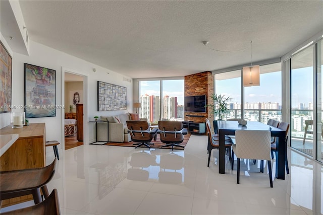 dining space featuring light tile patterned floors, floor to ceiling windows, and a textured ceiling