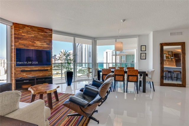 living room with floor to ceiling windows and a textured ceiling