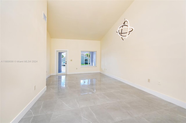 empty room featuring vaulted ceiling