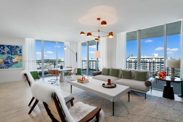 living room featuring a chandelier and a wall of windows