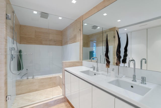 bathroom with vanity and shower with separate bathtub