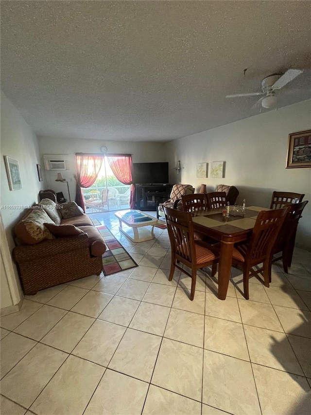 tiled dining room with ceiling fan and a textured ceiling