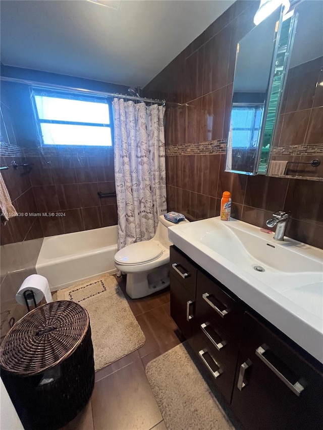 full bathroom with vanity, toilet, tile walls, and tile patterned flooring