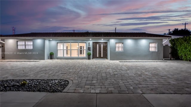 back house at dusk with french doors