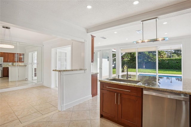 kitchen featuring a wealth of natural light, sink, stainless steel appliances, and decorative light fixtures