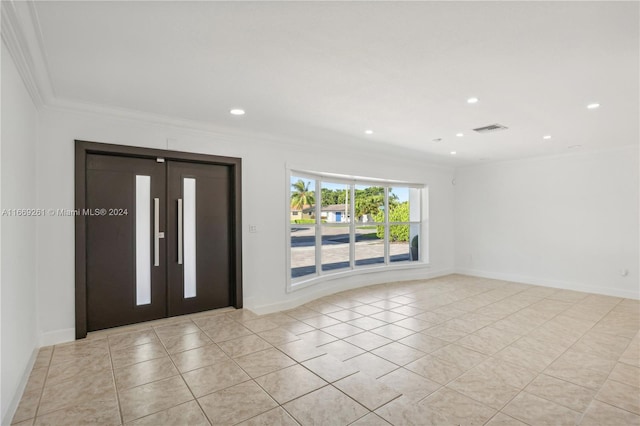 tiled entryway featuring ornamental molding