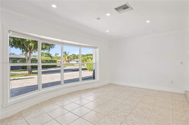 tiled spare room with ornamental molding