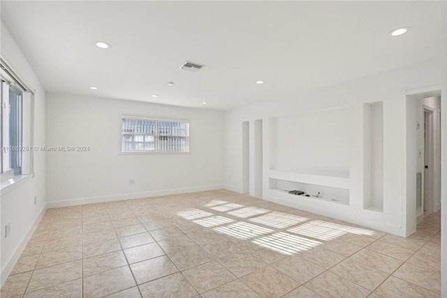 tiled empty room with built in shelves