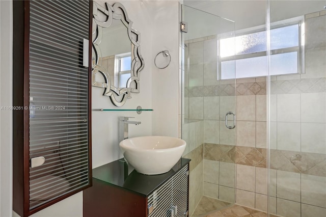 bathroom with vanity, tile patterned flooring, walk in shower, and a healthy amount of sunlight