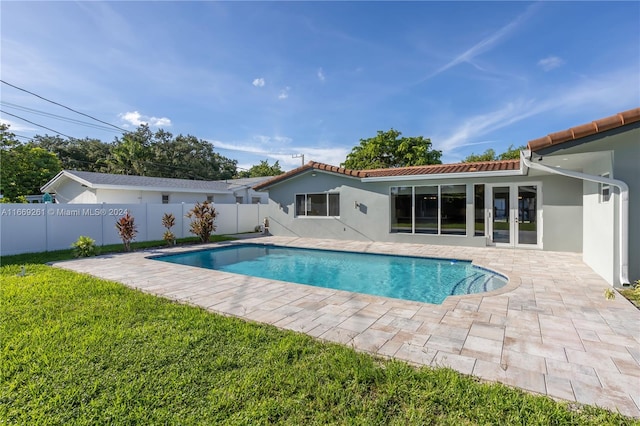 view of swimming pool with a patio area and a yard