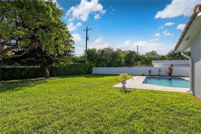 view of yard with a fenced in pool