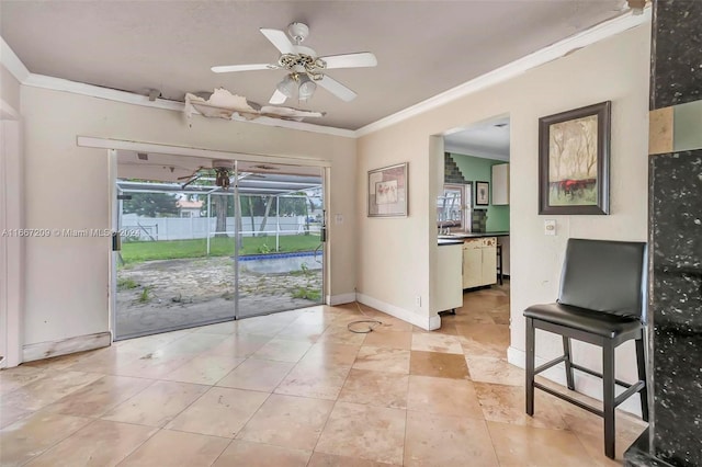 interior space featuring crown molding, sink, and ceiling fan