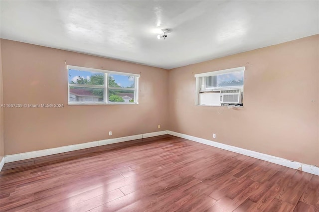 unfurnished room featuring hardwood / wood-style floors and cooling unit