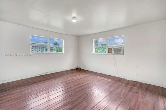 unfurnished room featuring cooling unit and wood-type flooring