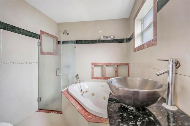 bathroom featuring tile patterned flooring, sink, and plus walk in shower