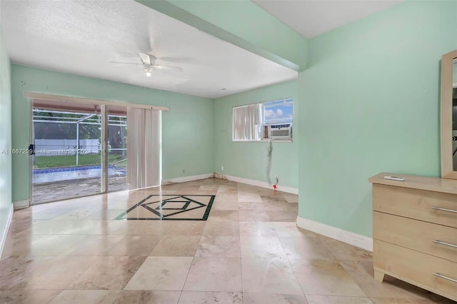 empty room featuring ceiling fan and a textured ceiling