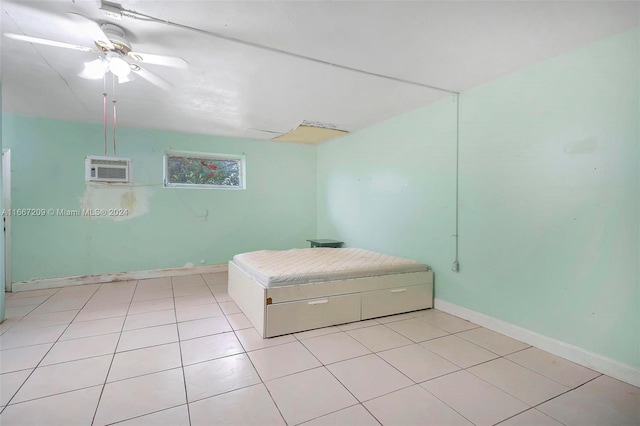 unfurnished bedroom featuring a wall mounted AC, ceiling fan, and light tile patterned floors