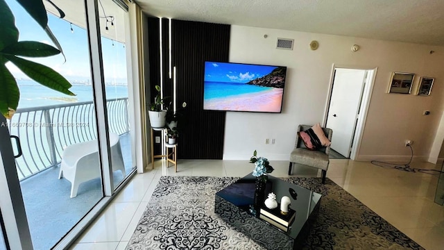 living room with a textured ceiling and light tile patterned floors