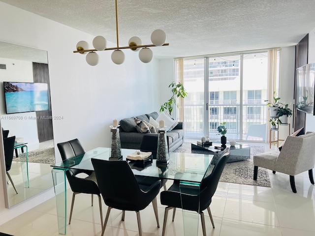 tiled dining room featuring a textured ceiling and a wall of windows