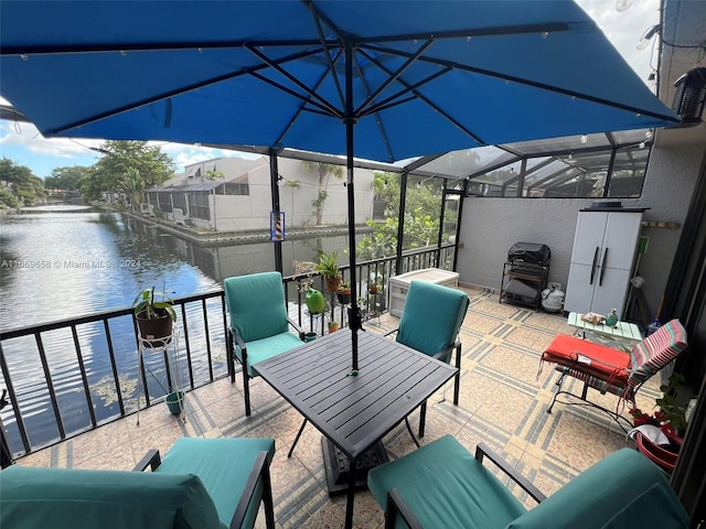 view of patio featuring outdoor lounge area, a water view, and glass enclosure