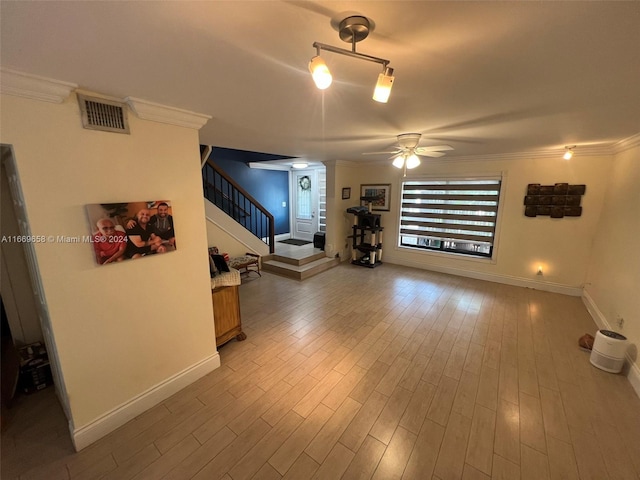 unfurnished living room with hardwood / wood-style flooring, ceiling fan, and crown molding