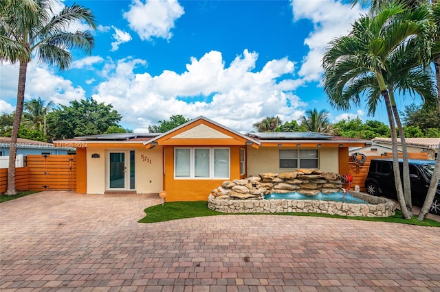 view of front of property with solar panels