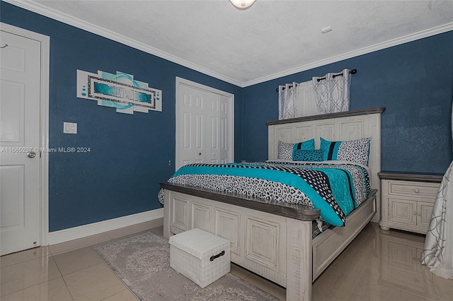 tiled bedroom with a textured ceiling, ornamental molding, and a closet