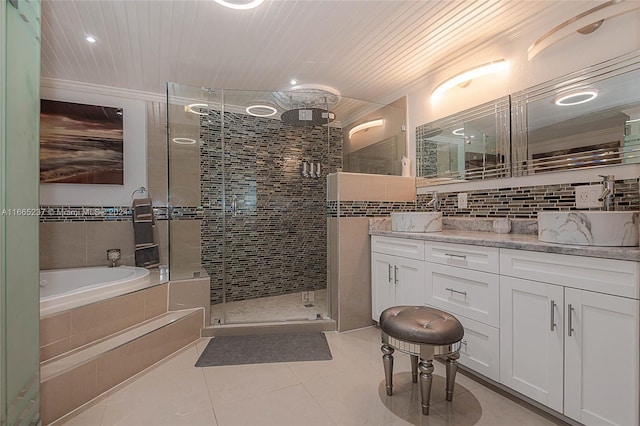 bathroom with tile walls, shower with separate bathtub, tile patterned floors, and vanity