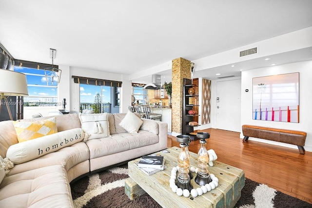 living room featuring wood-type flooring and a chandelier