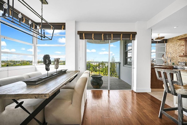 dining area featuring an inviting chandelier, a wealth of natural light, and hardwood / wood-style floors