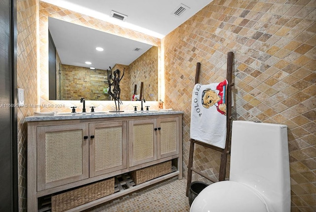 bathroom featuring tile walls and vanity