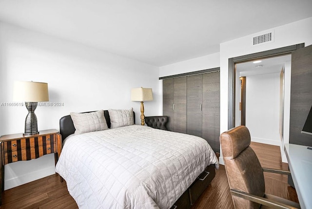 bedroom featuring dark hardwood / wood-style flooring and a closet