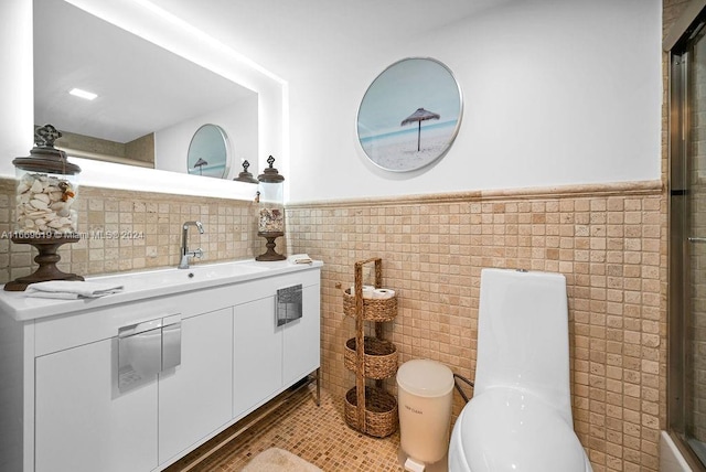 bathroom featuring tile walls and toilet