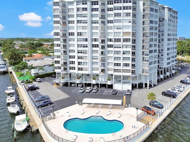 exterior space with a community pool and a water view