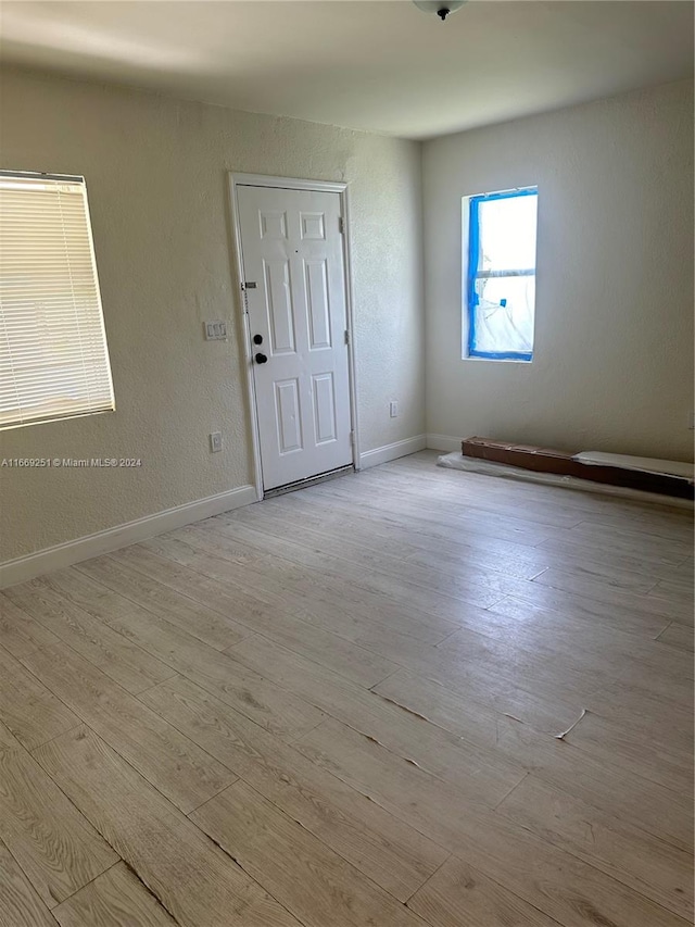 spare room with light hardwood / wood-style flooring