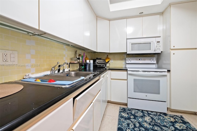 kitchen featuring white cabinetry, white appliances, backsplash, and light tile patterned floors