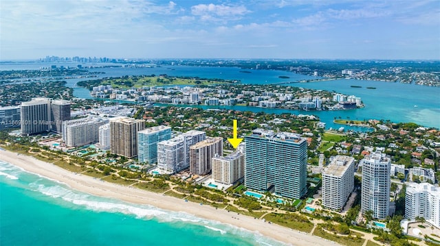 aerial view with a water view and a beach view