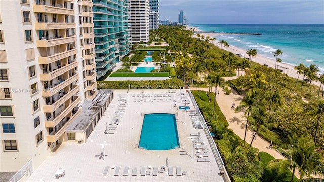 drone / aerial view with a water view and a view of the beach