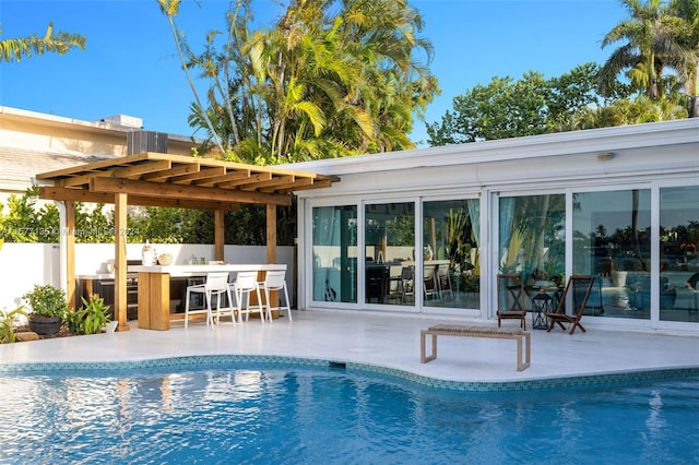 view of swimming pool with a patio and a pergola