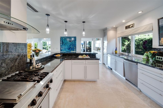 kitchen featuring white cabinets, pendant lighting, sink, appliances with stainless steel finishes, and decorative backsplash