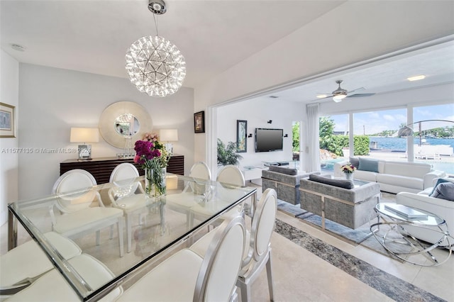 dining room featuring ceiling fan with notable chandelier and light tile patterned floors