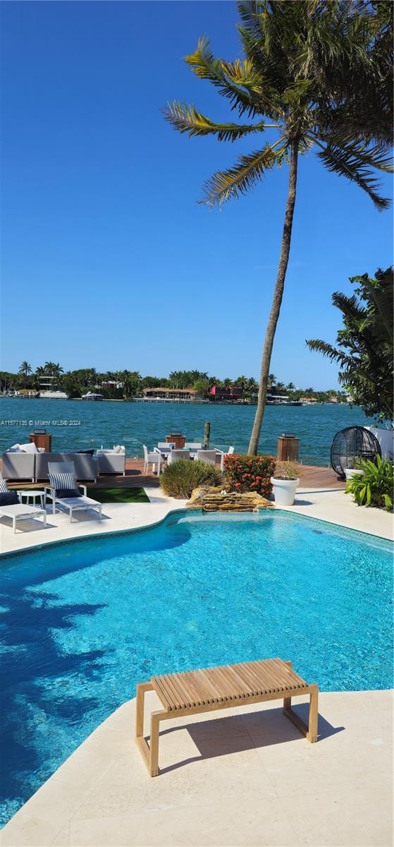 view of swimming pool featuring a water view