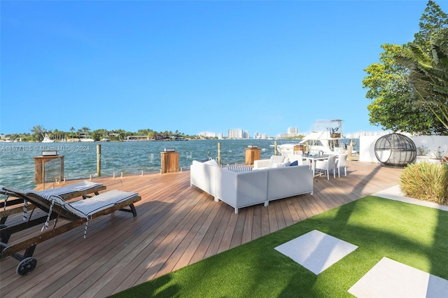 view of dock featuring a water view and a yard