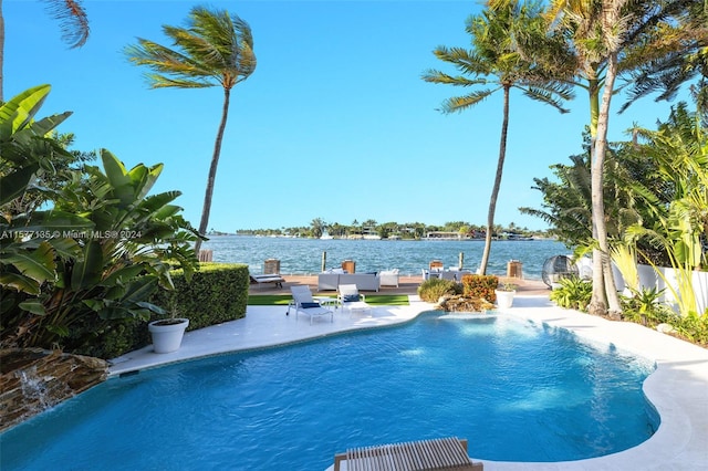 view of swimming pool featuring a water view, a patio, and pool water feature