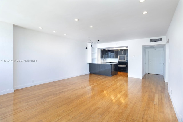 unfurnished living room featuring light hardwood / wood-style floors