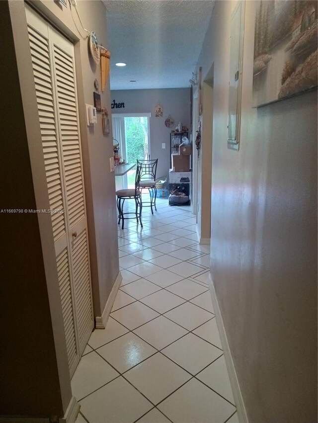 kitchen with appliances with stainless steel finishes, light tile patterned floors, white cabinetry, and sink