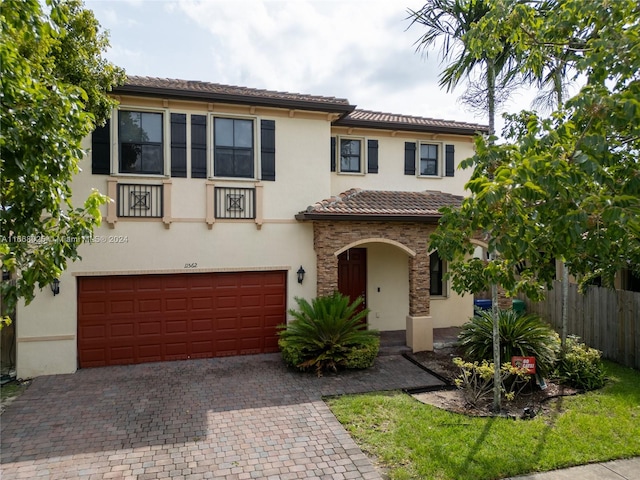 mediterranean / spanish home with a garage