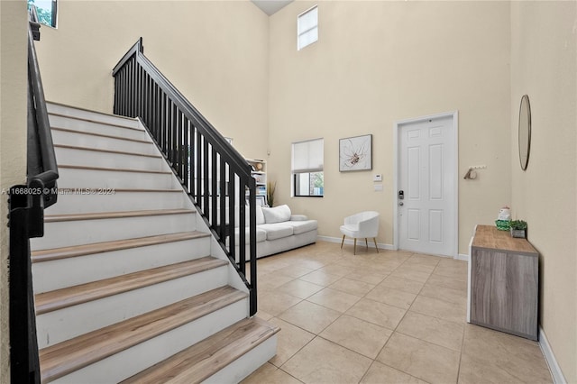 foyer featuring a high ceiling and light tile patterned floors